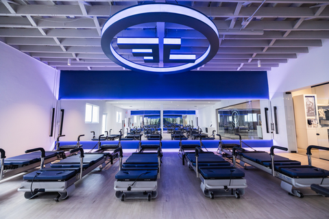 JETSET Pilates flagship studio with illuminated JS logo and reformers arranged in a modern training space